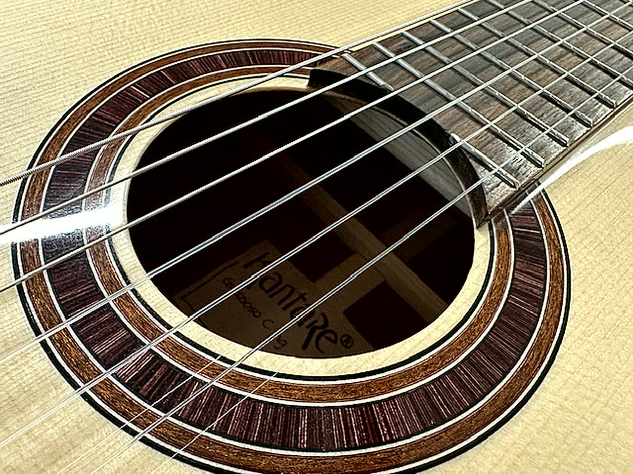 Close-up of the spruce top and rosette of a Kantare classical guitar